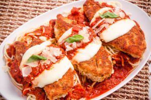 Baked Chicken Parmesan on plate with pasta