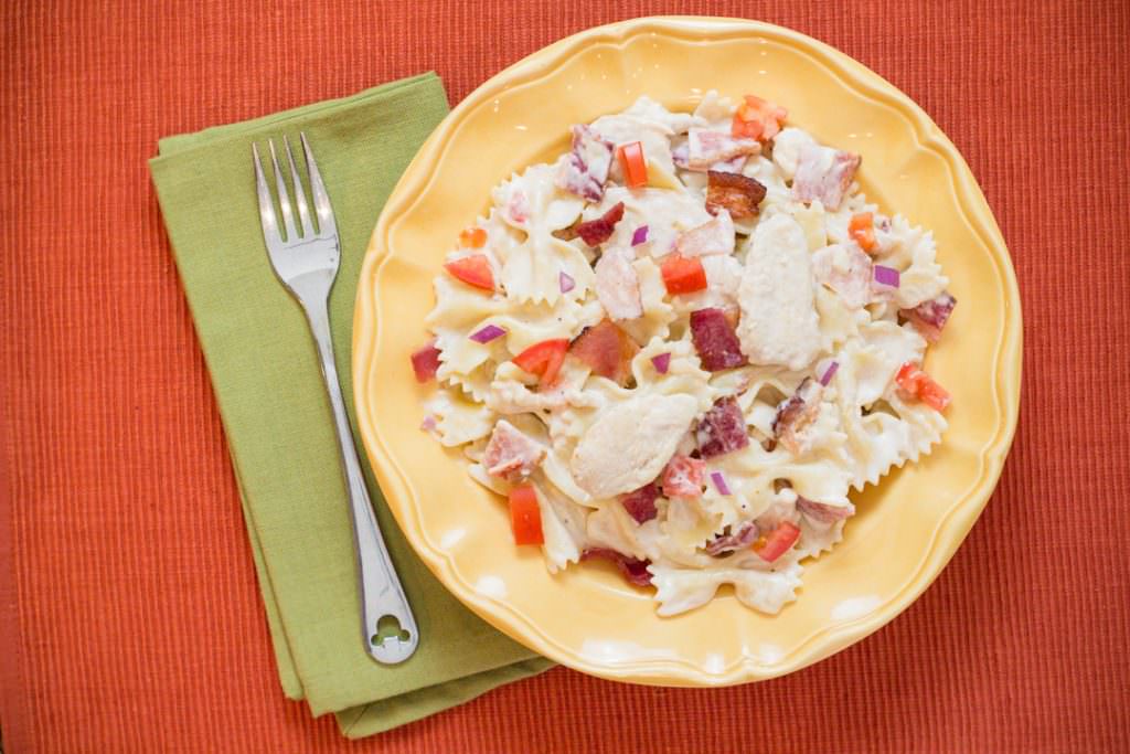 Chicken Carbonara-a dinner recipe for Instant Pot with Chicken, Bacon, Tomatoes, and Red Onion served over Bowtie Pasta