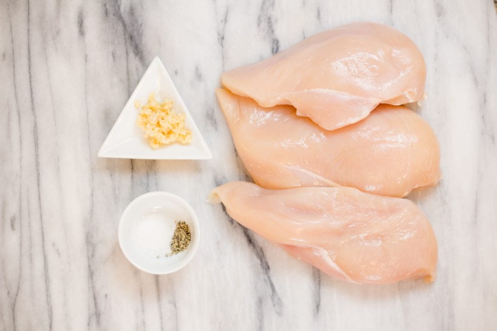 Chicken on marble cutting board for Shredded Chicken