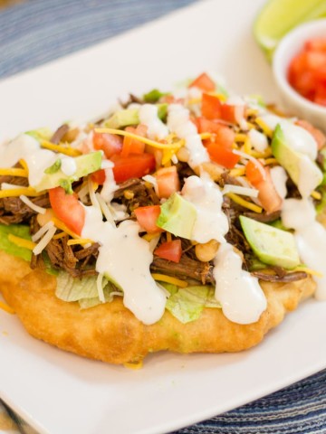 Navajo Taco with Indian Fry Bread, shredded marinated Beef and taco toppings