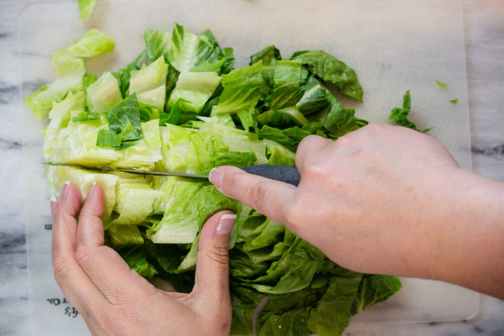 Romain Lettuce being cut for BLT Salad