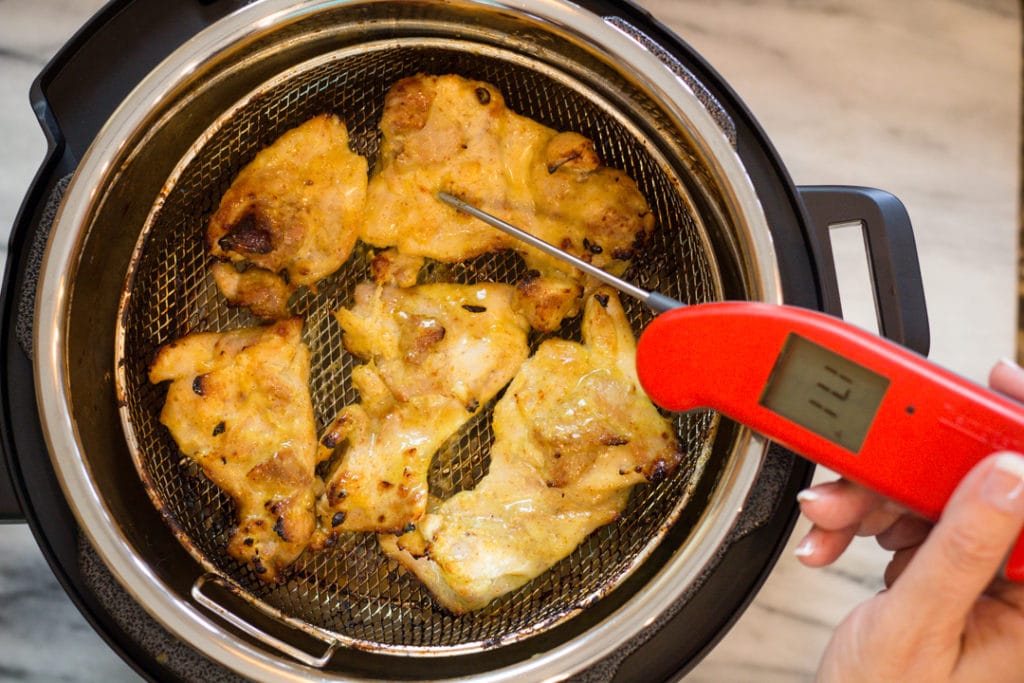 Taking temperature of Chicken Thighs