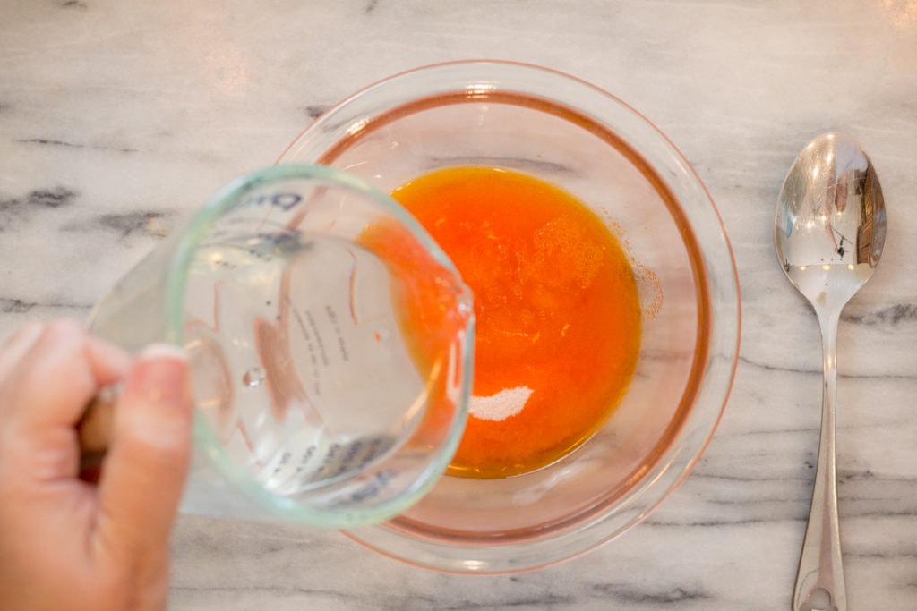 Mixing Orange Jello in bowl for Orange Fluff Salad
