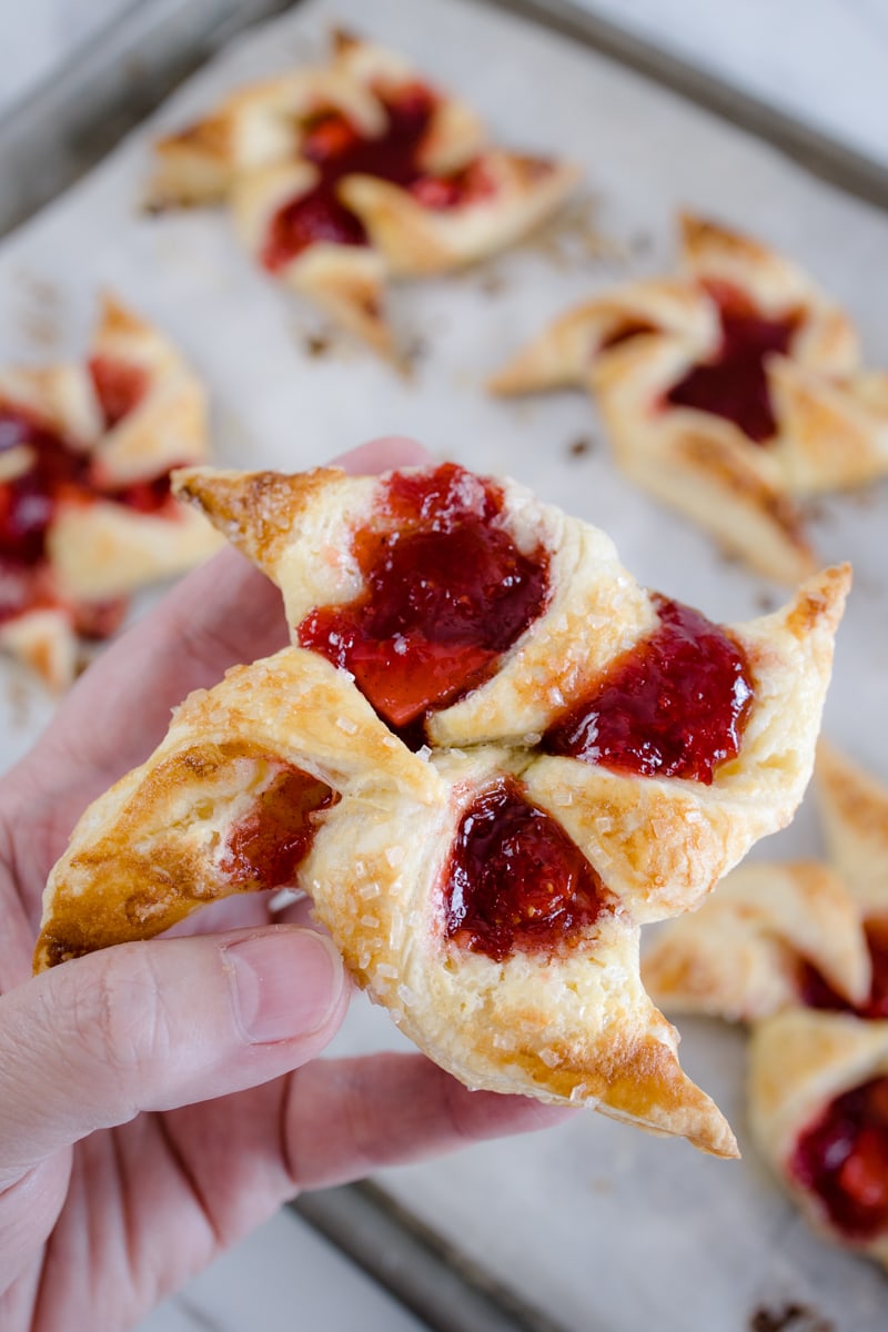These adorable Pinwheel Danish treats are filled with sweetened Strawberries, Rhubarb, and a creamy cream cheese filling. The WOW factor is big with this dessert recipe and for good reason. I’ve got all the tips and tricks to making Rhubarb Cream Cheese Danish and you will LOVE them. #devourdinner #devourpower #dessert #easydessert #rhubarb #strawberryrubarbpinwheeldanish #springsweetsweek #dixiecrystals #melissasproduce #cooksillustrated #foodgawker #bareaders s#mywilliamsonoma #imsomartha