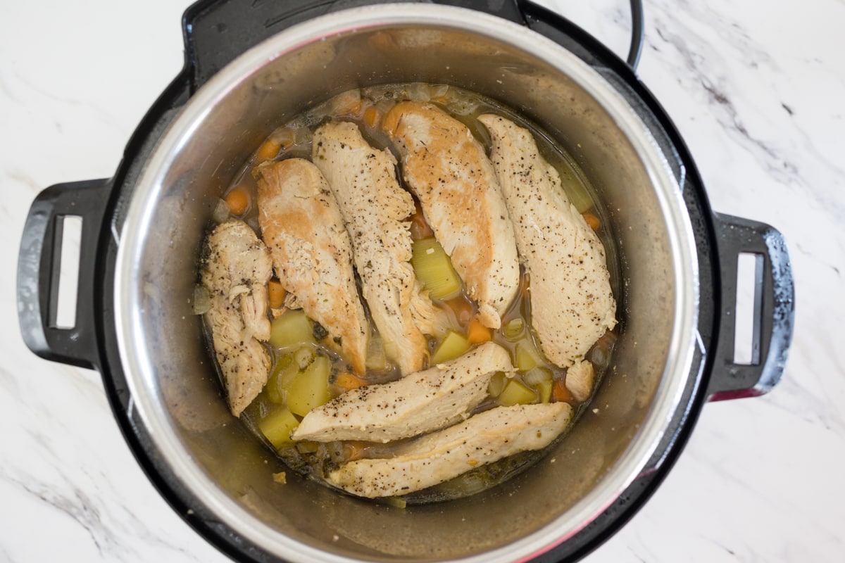 Instant Pot with Ingredients and chicken on top