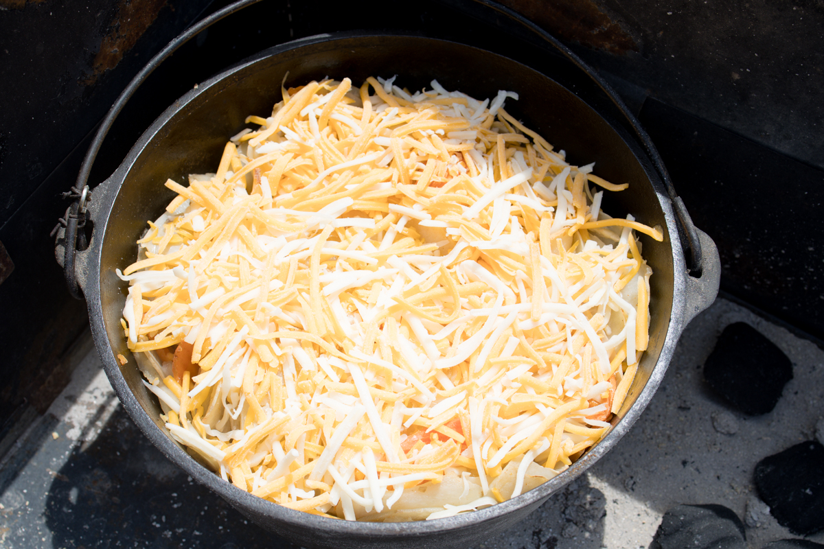 Cheese on top of potatoes in Dutch Oven