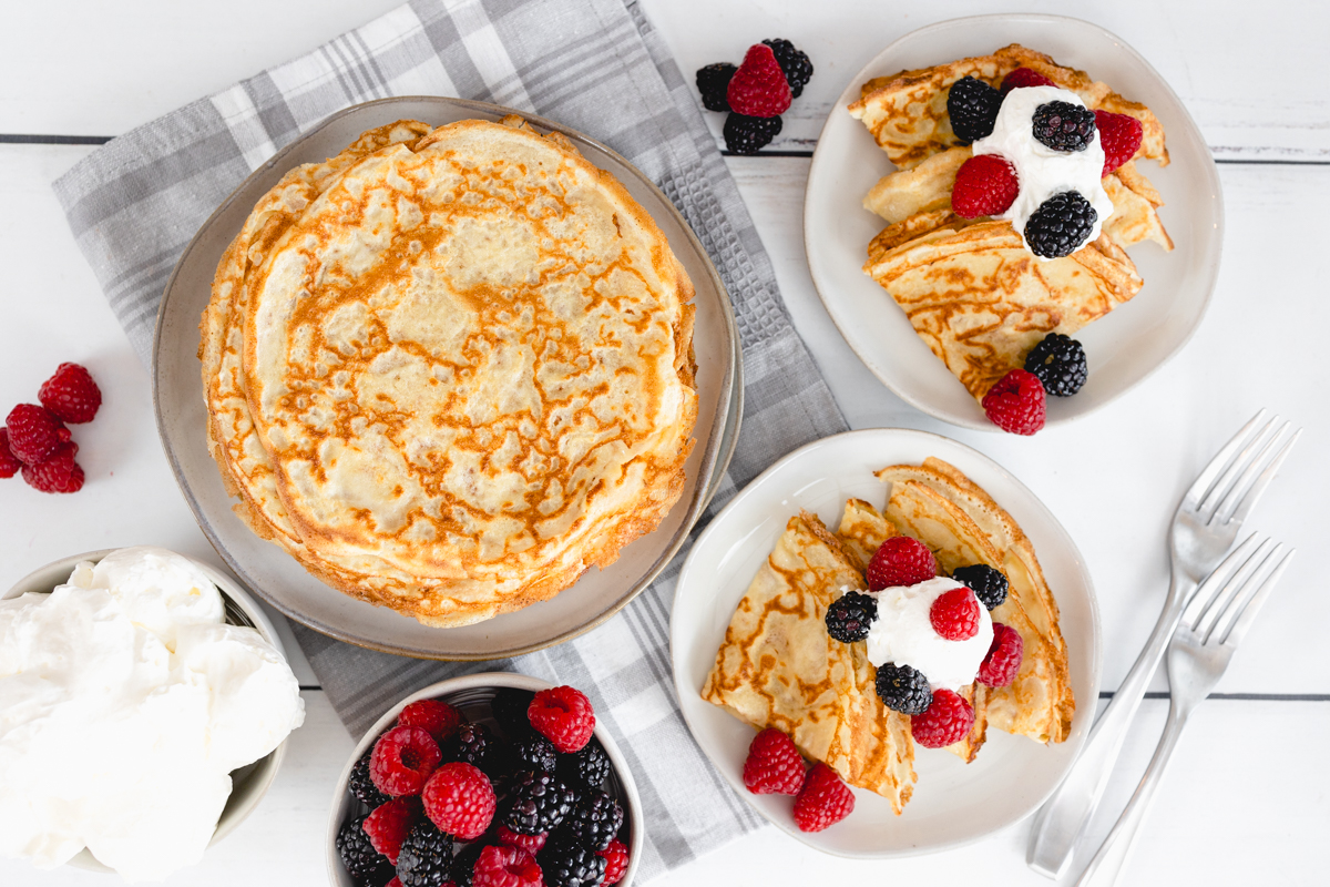 Crepes with whipping cream and berries