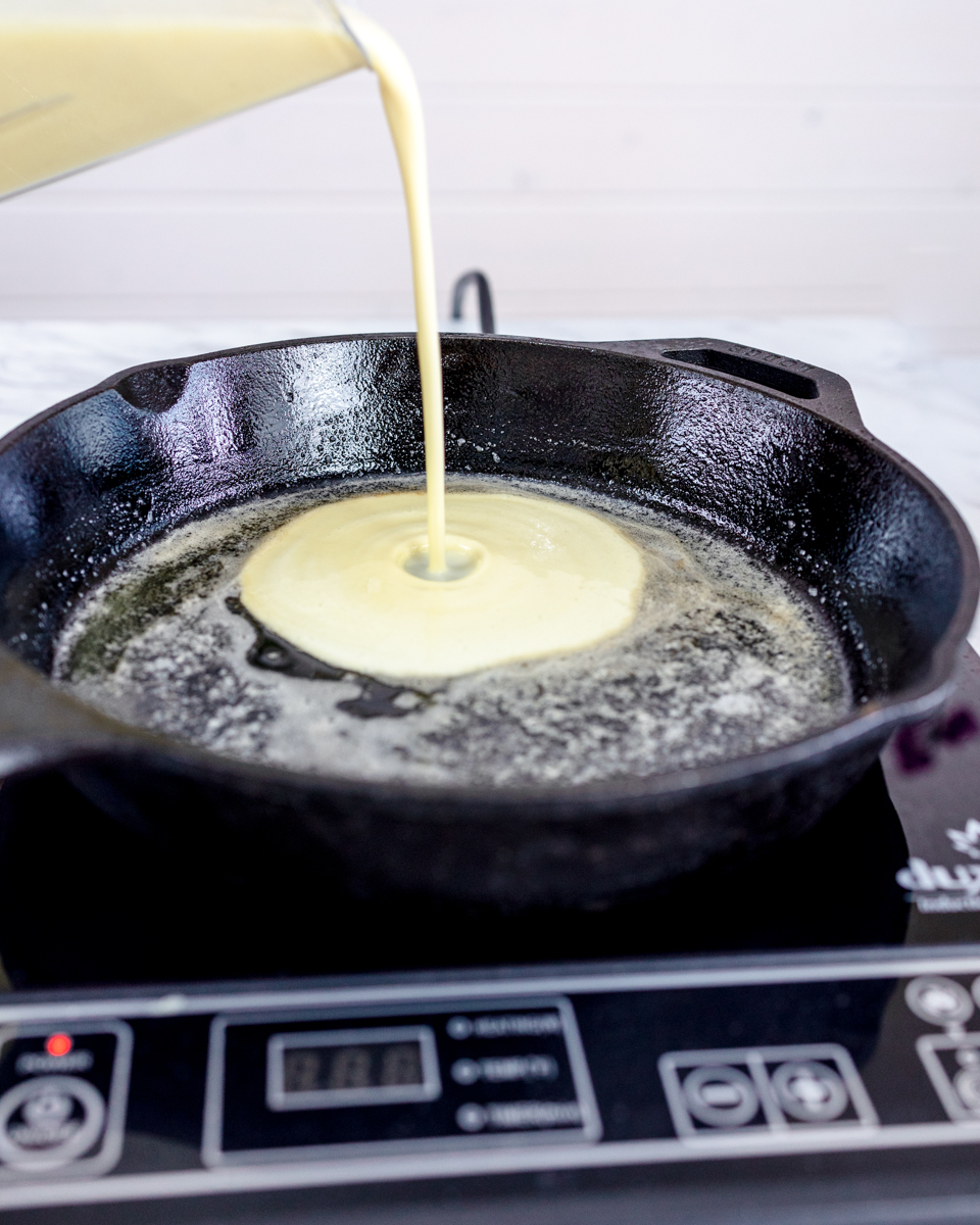 Pour Batter into Hot Cast Iron Skillet with Melted Butter