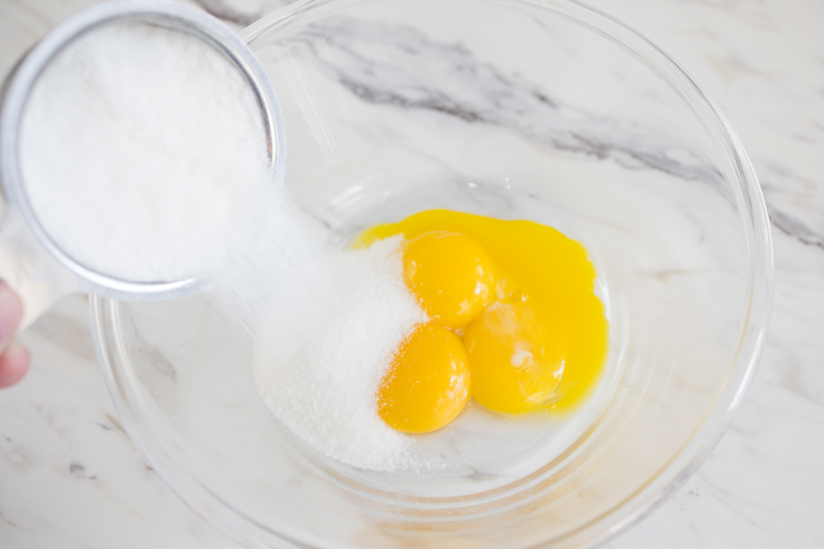 Egg yolks and sugar in bowl