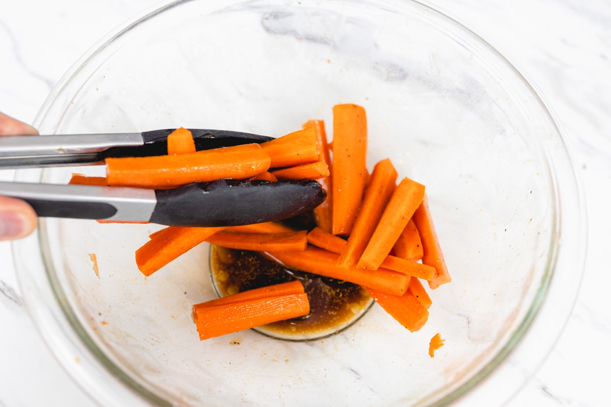 Sliced Carrots in bowl with seasoning