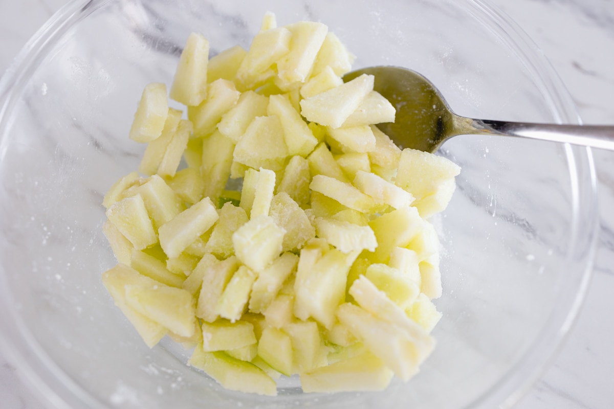 Peeled, cored, sliced apple in bowl