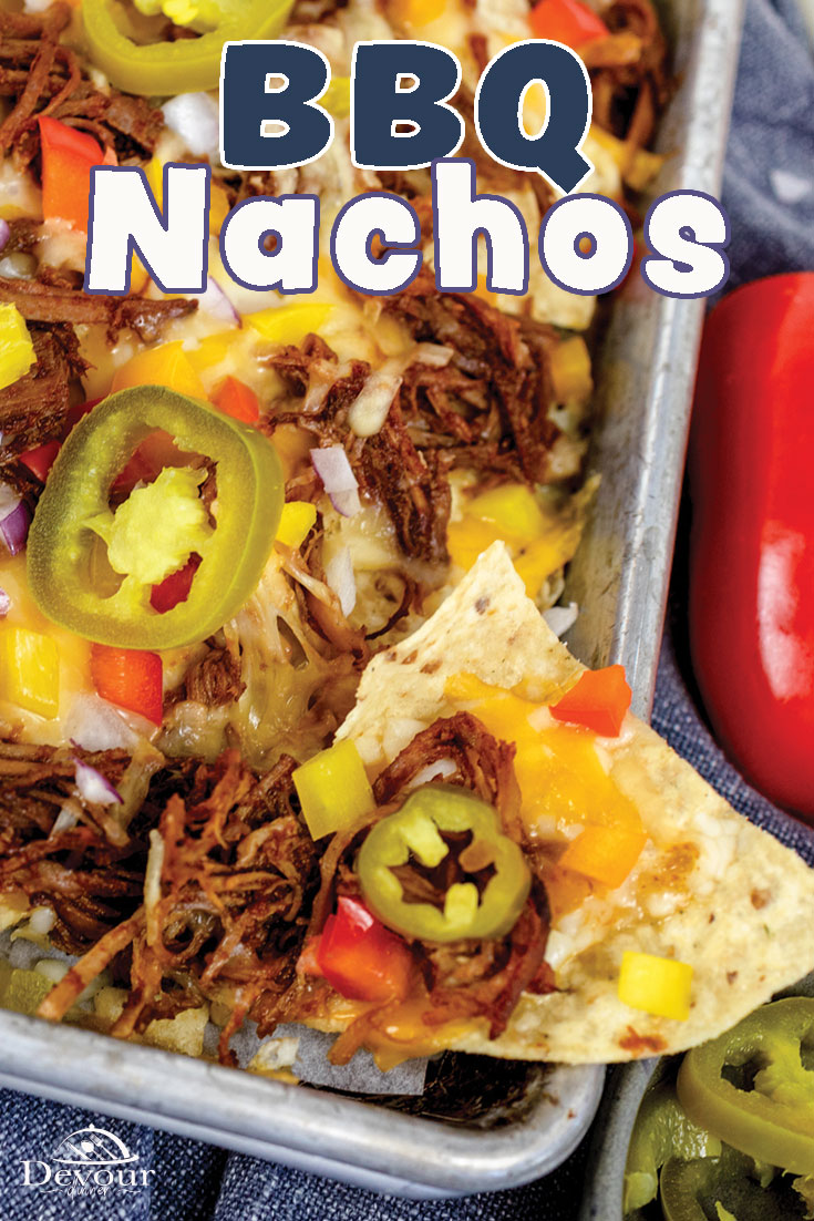 Pork BBQ Nachos using leftover pulled pork and loaded with cheese, onions, bell peppers, and BBQ Sauce on top of Tortilla Chips. Garnish with Cilantro, Sour Cream, Guacamole, Pico de Gallo, Salsa, and Queso Cheese. This easy Nacho recipe is a great 30 minute meal that feeds a crowd. Enjoy a large sheet pan of nachos and make memories around the table #devourdinner #BBQnachos #pulledporknacho