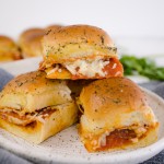 Close up of Pepperoni Pizza Sliders on a white plate.