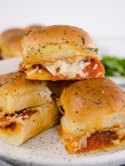 Close up of Pepperoni Pizza Sliders on a white plate.