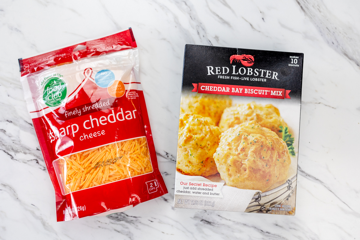 Top view of Red Lobster Cheddar Bay bisciut box mix and a packet of shredded cheddar cheese.