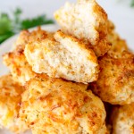 Close up of Red Lobster Biscuits in a pile on a white plate.