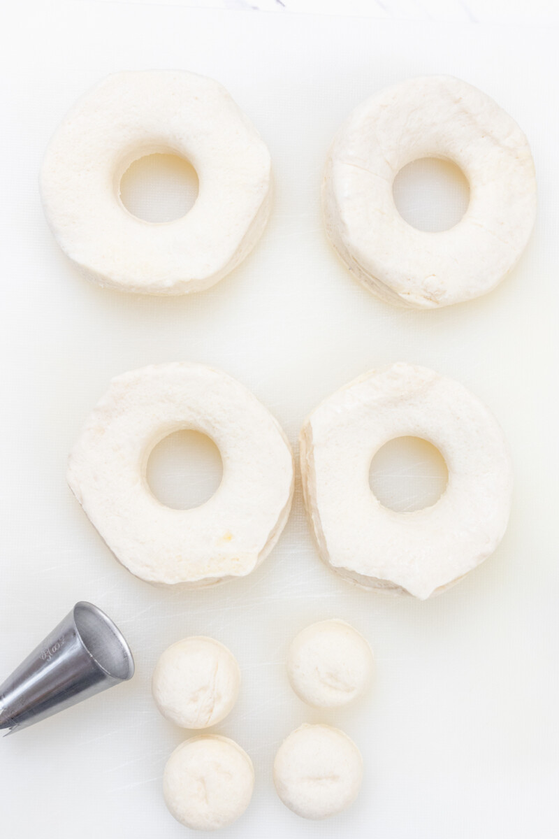 Top view of uncooked biscuits with holes cut from them.