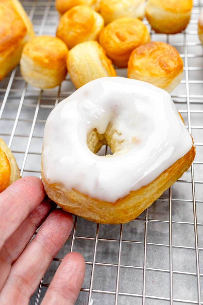 Close up view of a biscuit donut that has been dipped in icing.