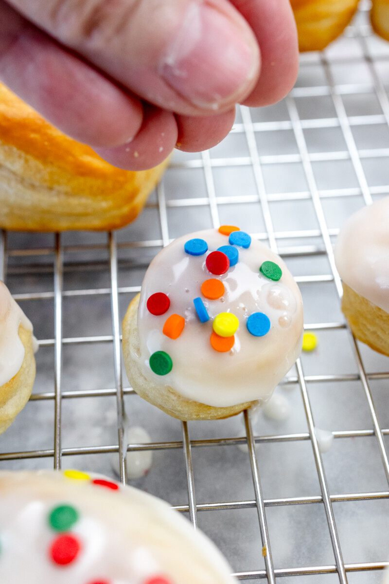 Close up view of an iced and decorated biscuit donut hole.