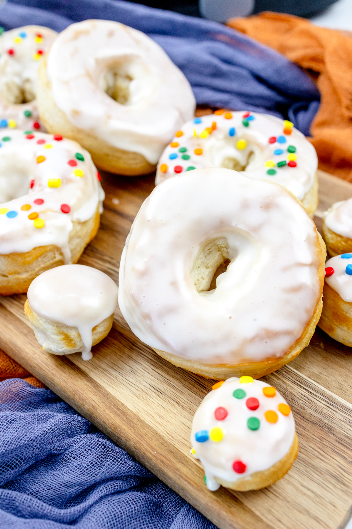 Close view of iced and decorated biscuit donuts and donut holes.