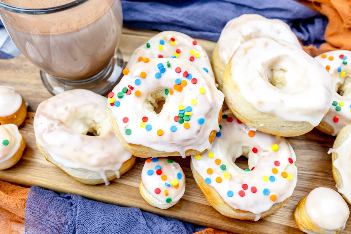 Close view of iced and decorated biscuit donuts and donut holes.