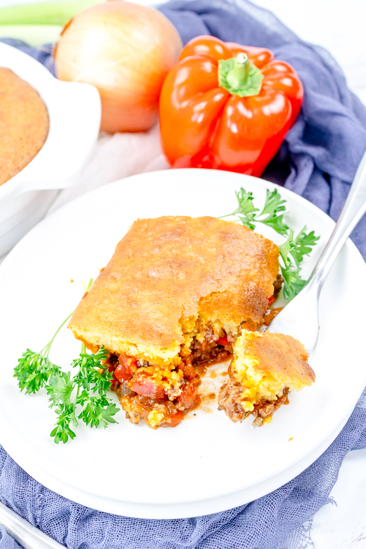 Close up view of a white plate that has sloppy joe casserole on it.