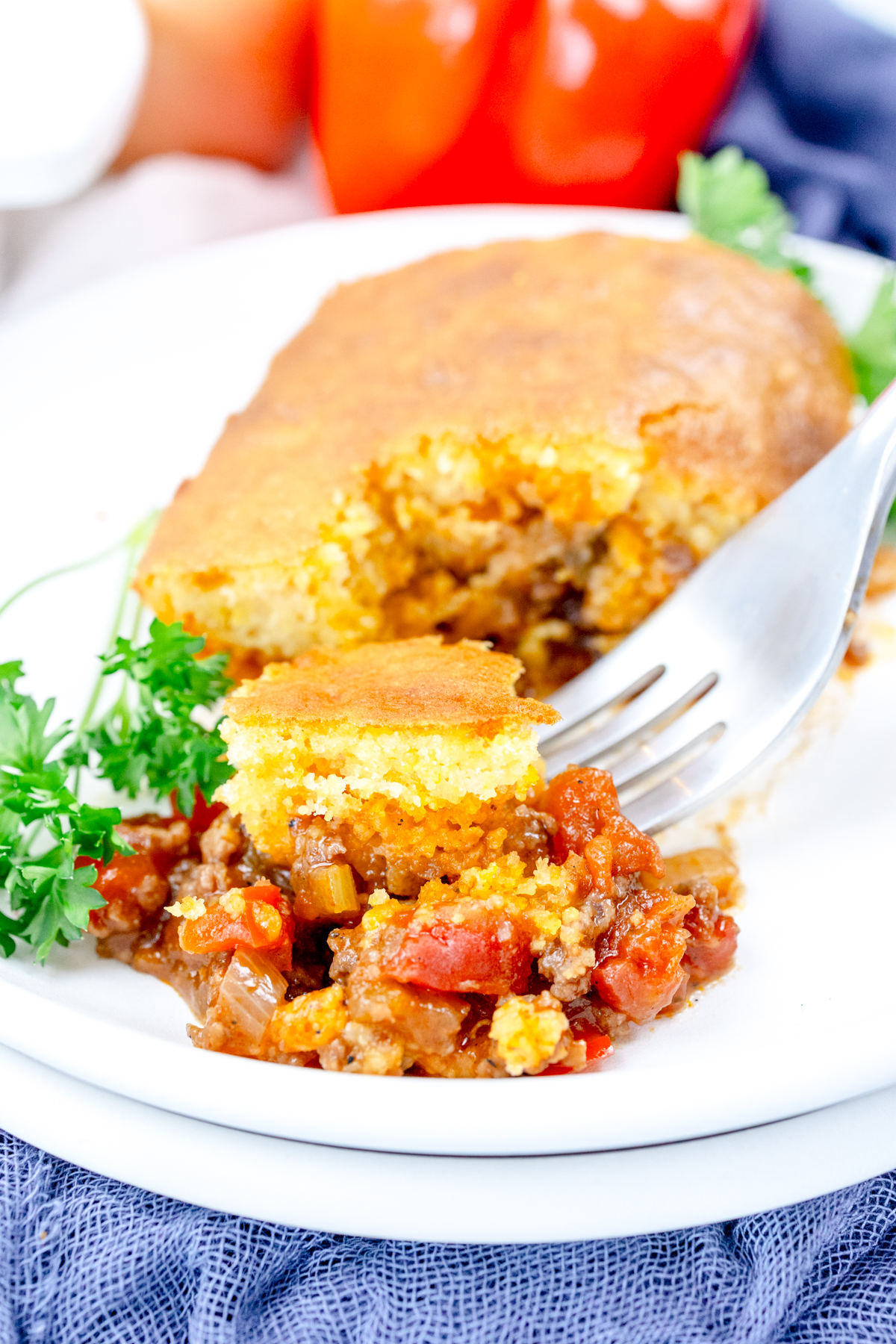 Close up view of a white plate that has sloppy joe casserole on it.