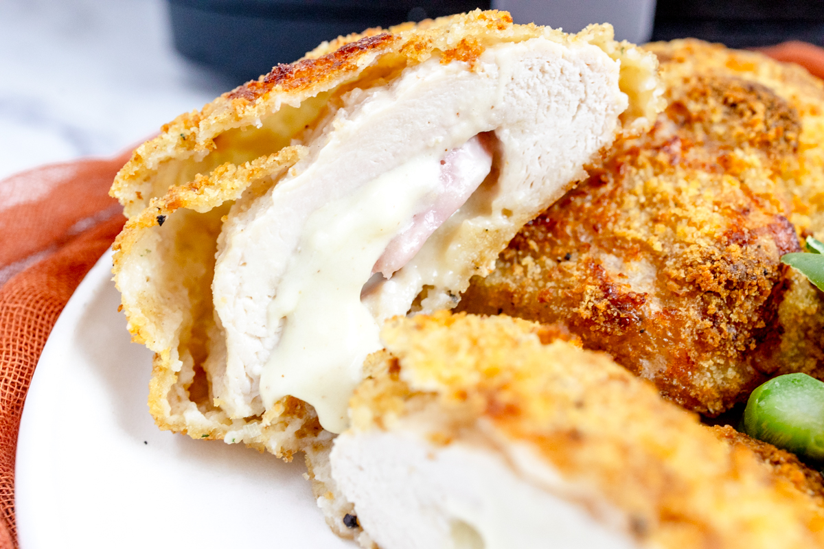 Angled view of Air Fried Chicken Cordon Bleu on a white plate.