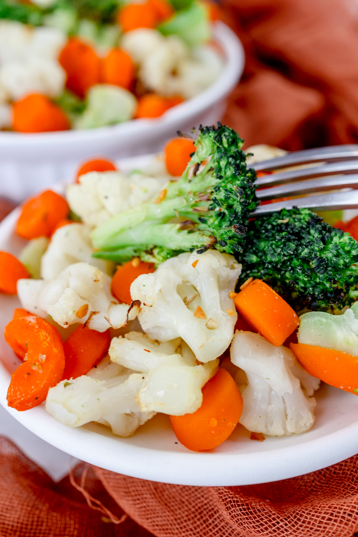 Close up view of a plate full of mixed vegetables.