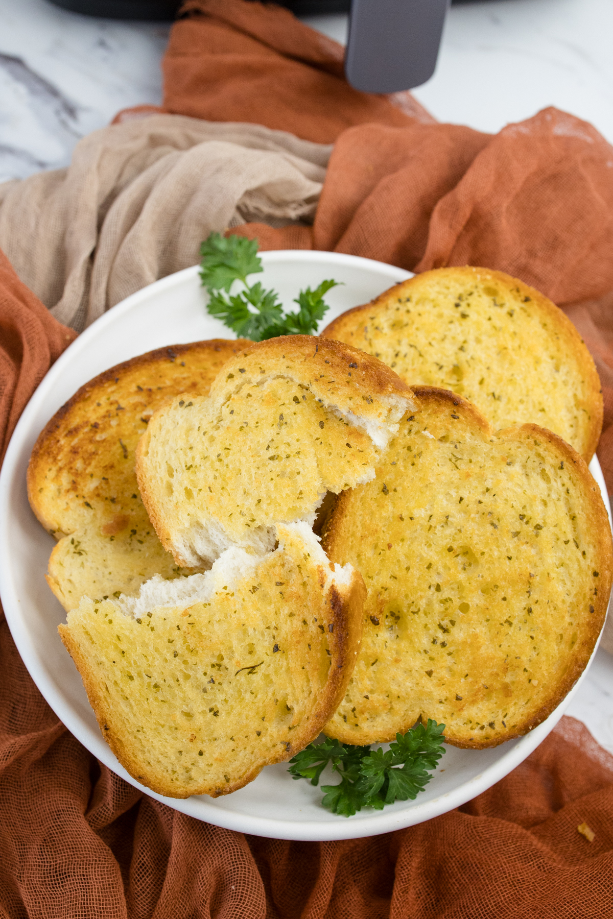 Top view of Texas Toast stacked on a white plate.
