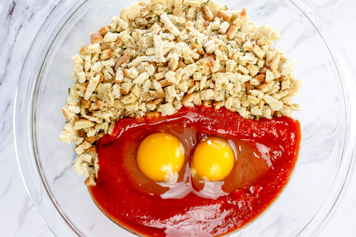 Top view of ingredients for meatloaf in a large mixing bowl.