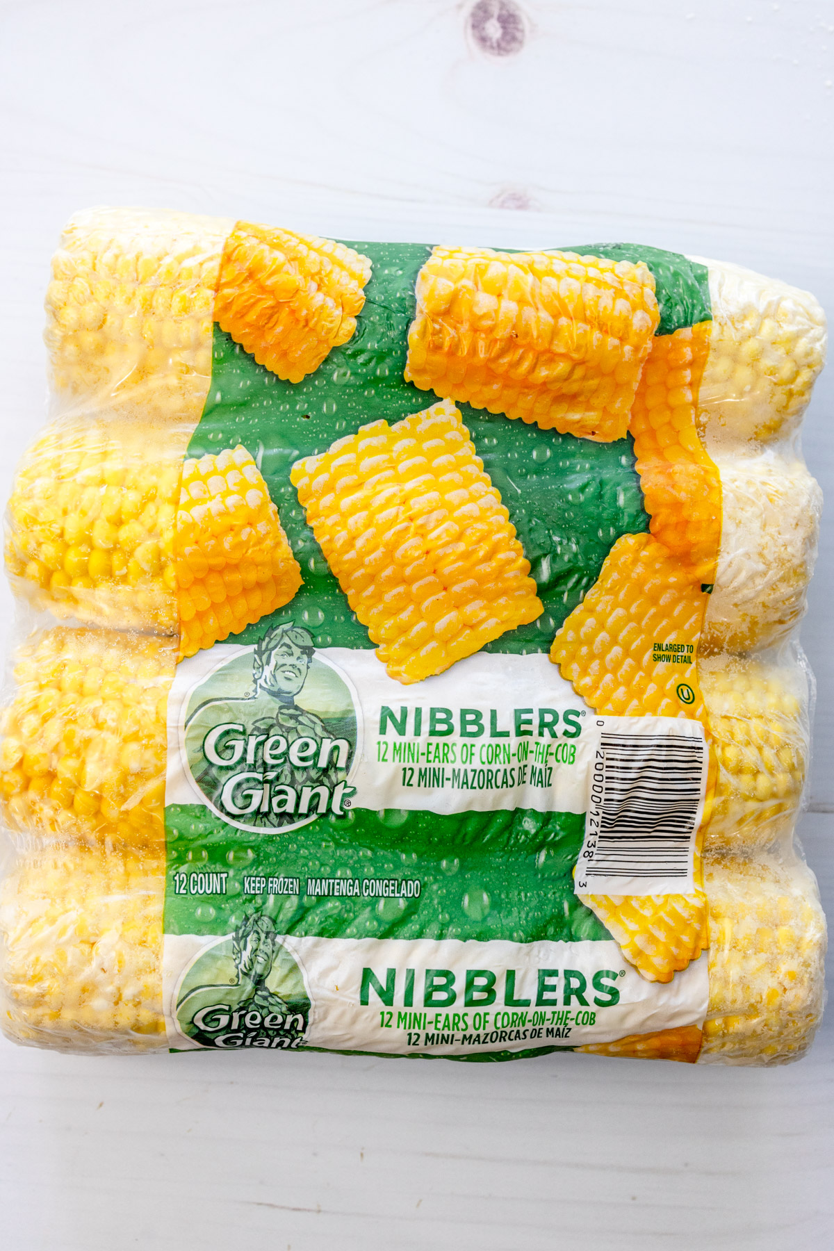 Overhead image of a package of frozen corn on the cobs.