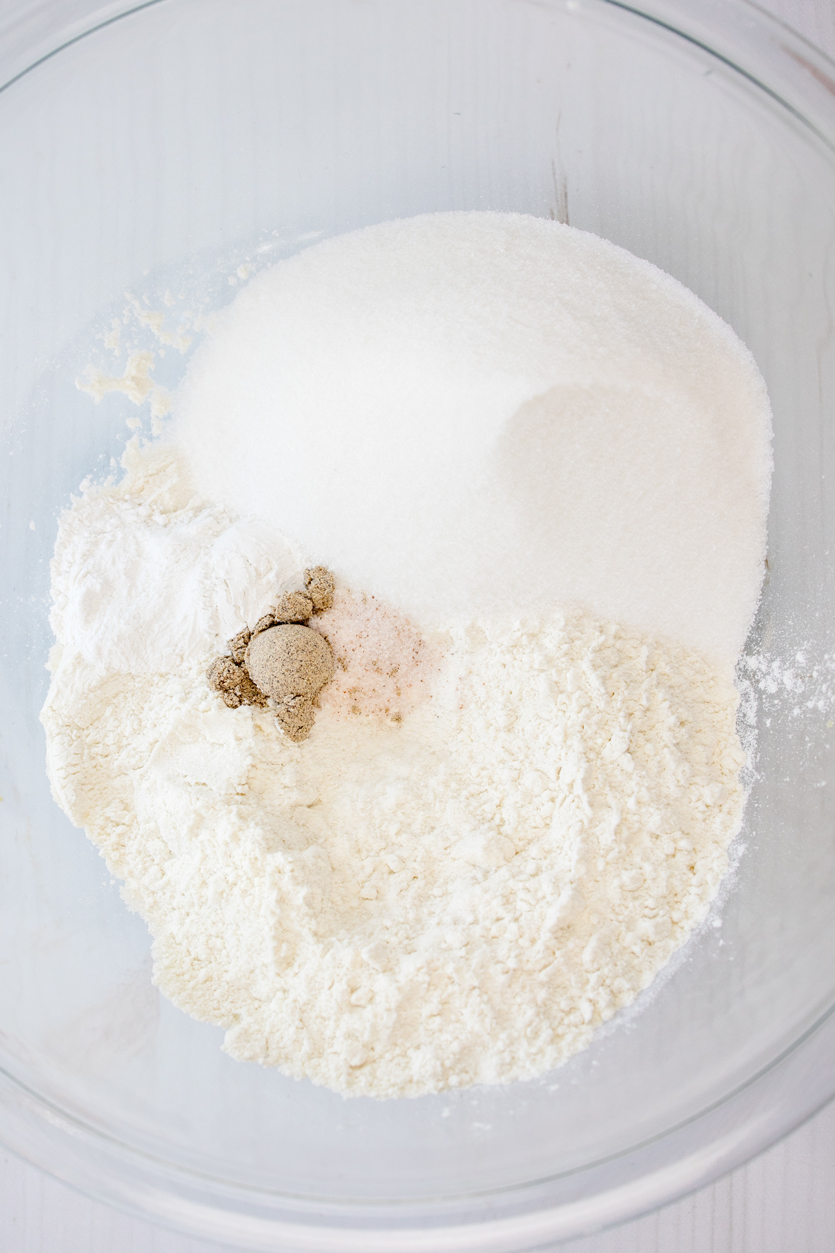 Close up image of a mixing bowl with dry ingredients needed for Cardamom Muffins.