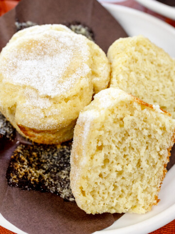 Square image of Cardamom Muffins on a white plate.