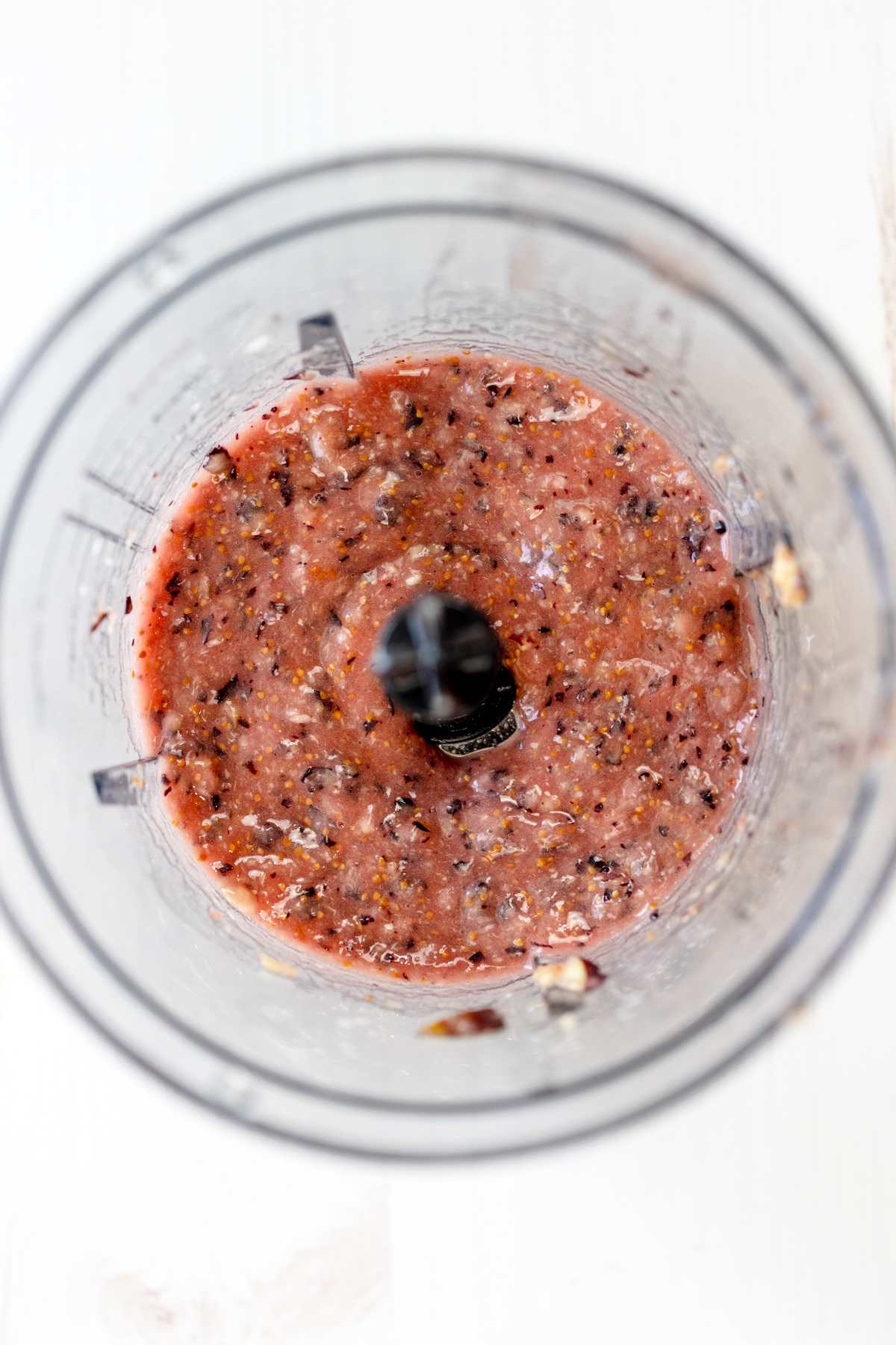 Overhead view of blended figs in a blender.