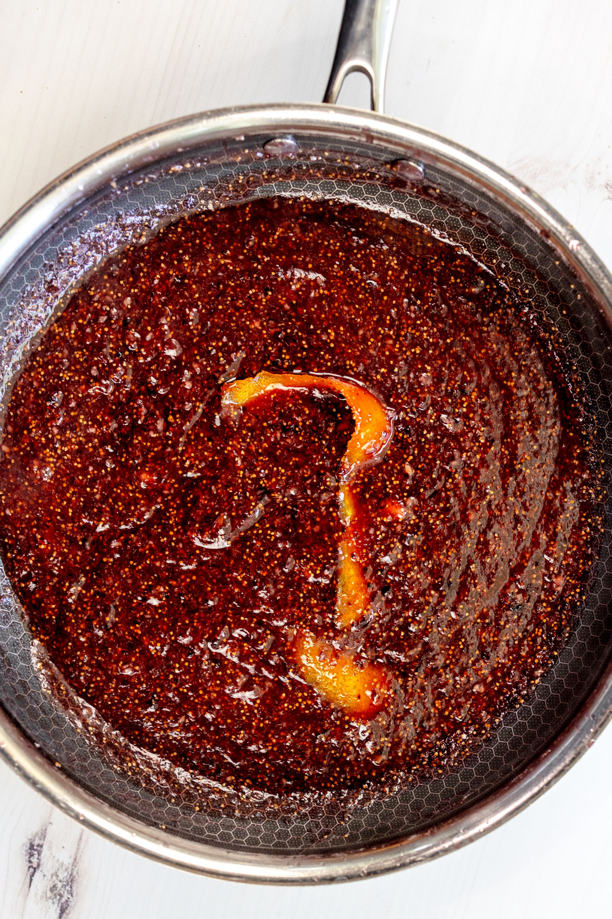 Overhead view of a saucepan with fig jam in it.