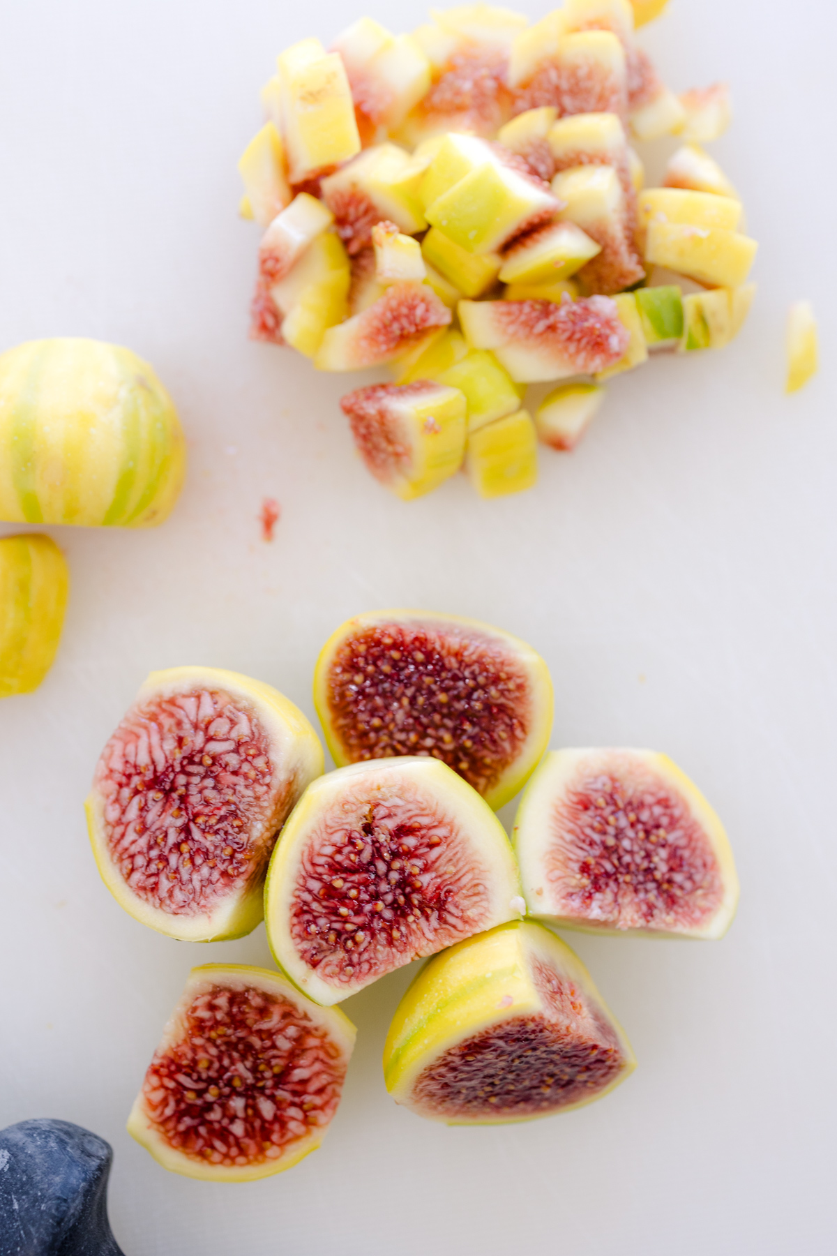 Overhead image of figs being sliced.