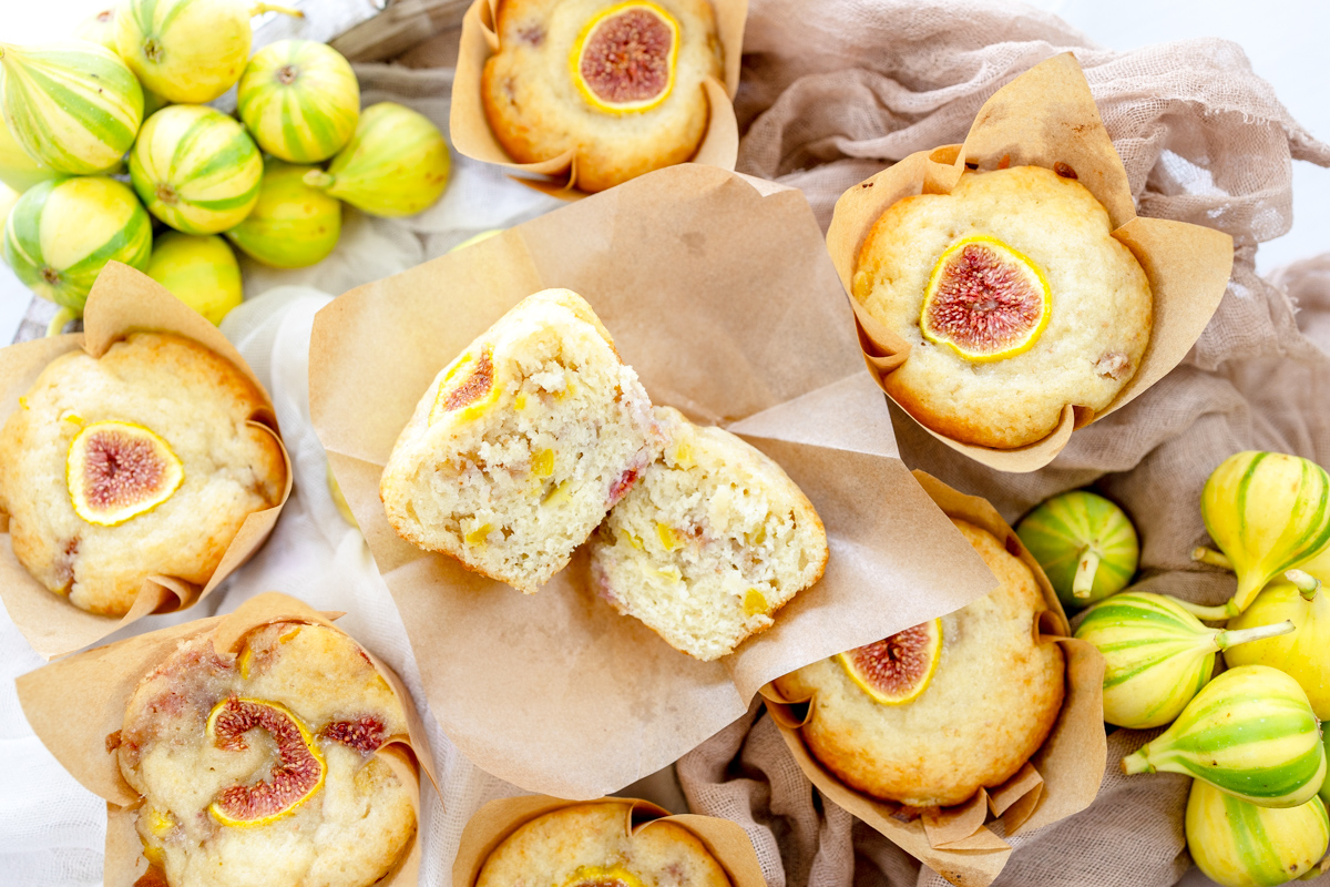 Overhead image of a fig muffin that has been sliced in half with other fig muffins around it.