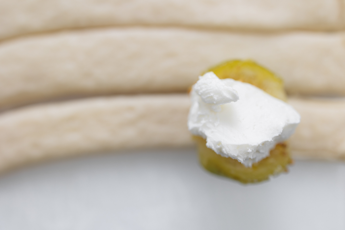 Close up image of a fig and cream cheese about to be rolled in pastry.