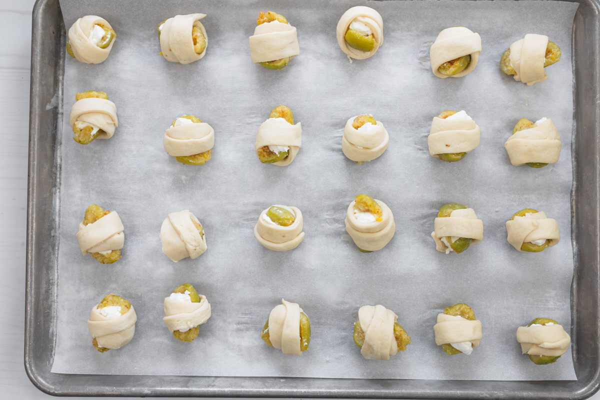 Overhead image of unbaked Figs in a Blanket on a baking tray lined with parchment paper.
