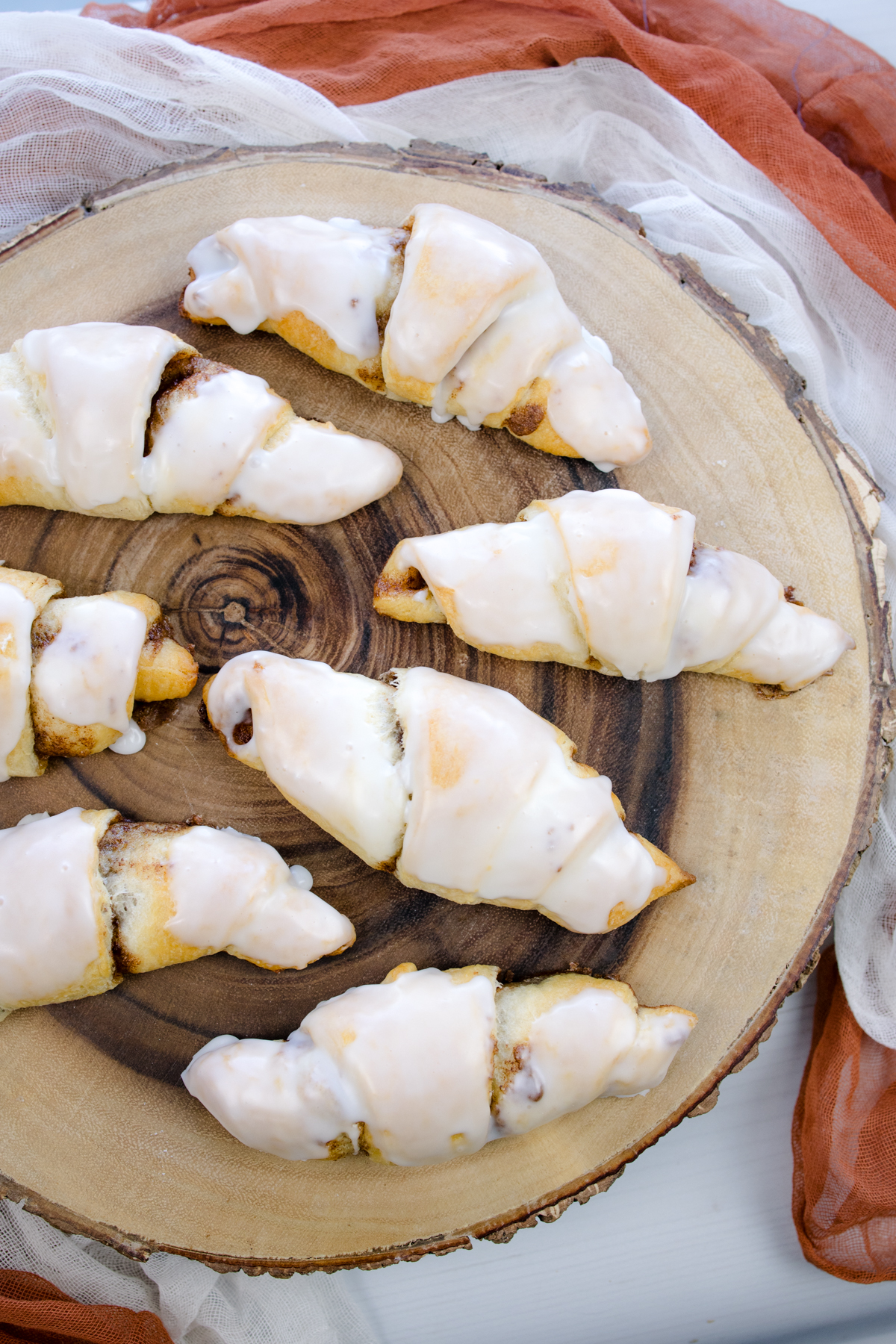 Overhead view of Cinnamon Crescent Rolls on a wooden surface.