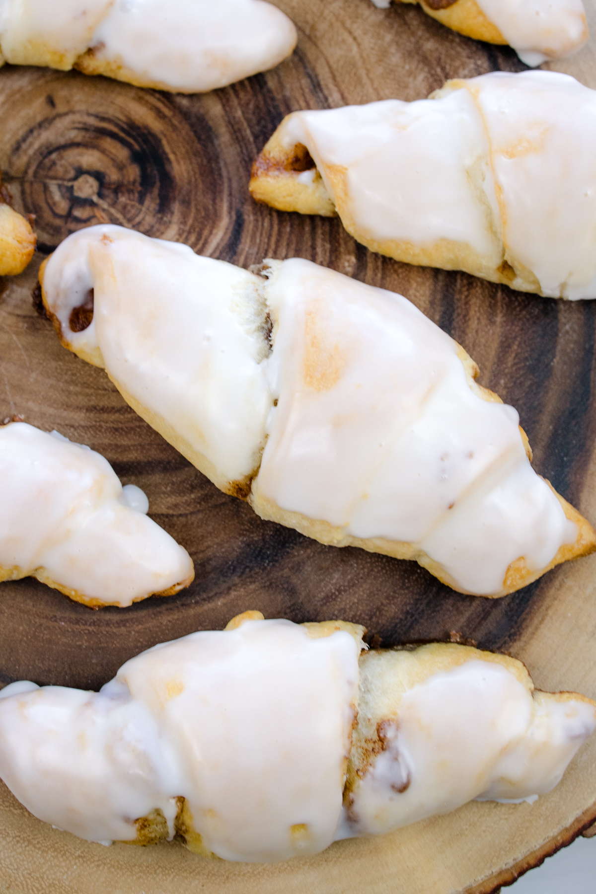 Close overhead view of Cinnamon Crescent Rolls on a wooden surface.
