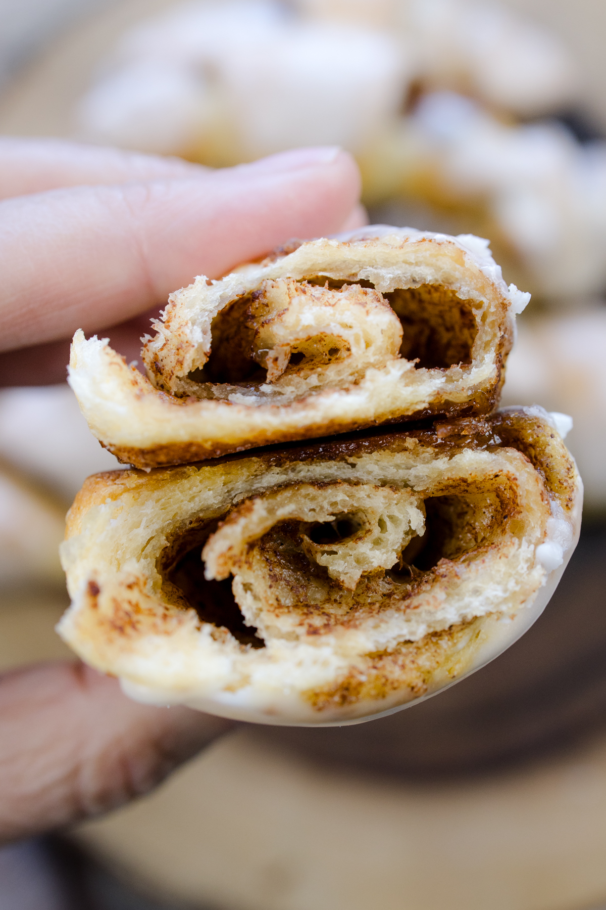 Close up view of a Cinnamon Crescent Rolls that has been sliced in half to reveal the middle.
