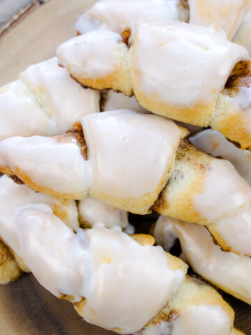 Cinnamon Crescent Rolls on cutting board with icing