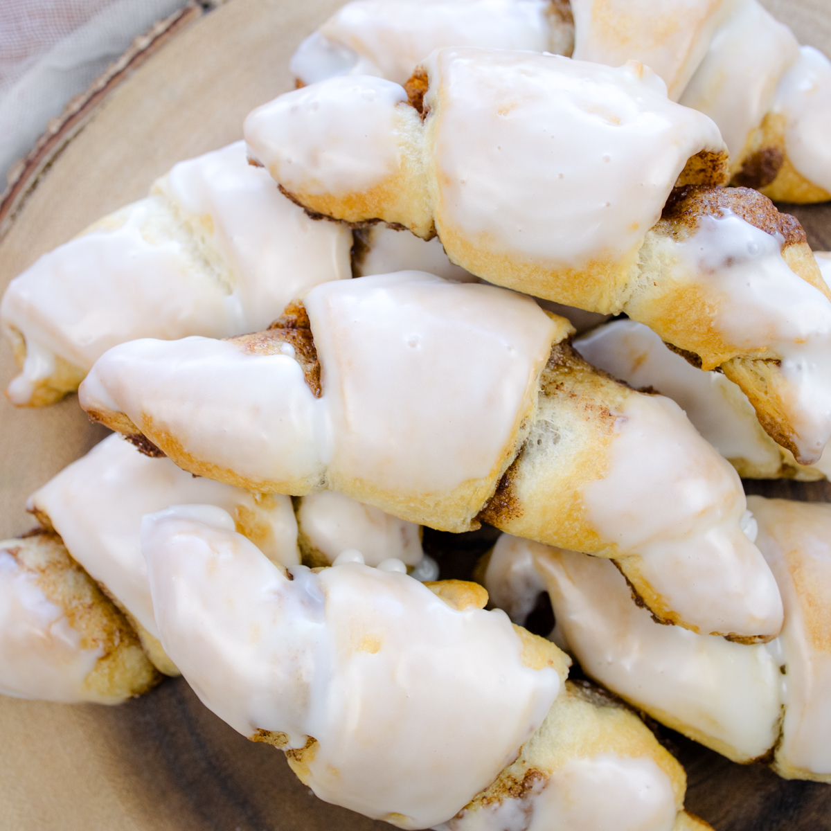 Cinnamon Crescent Rolls on cutting board with icing