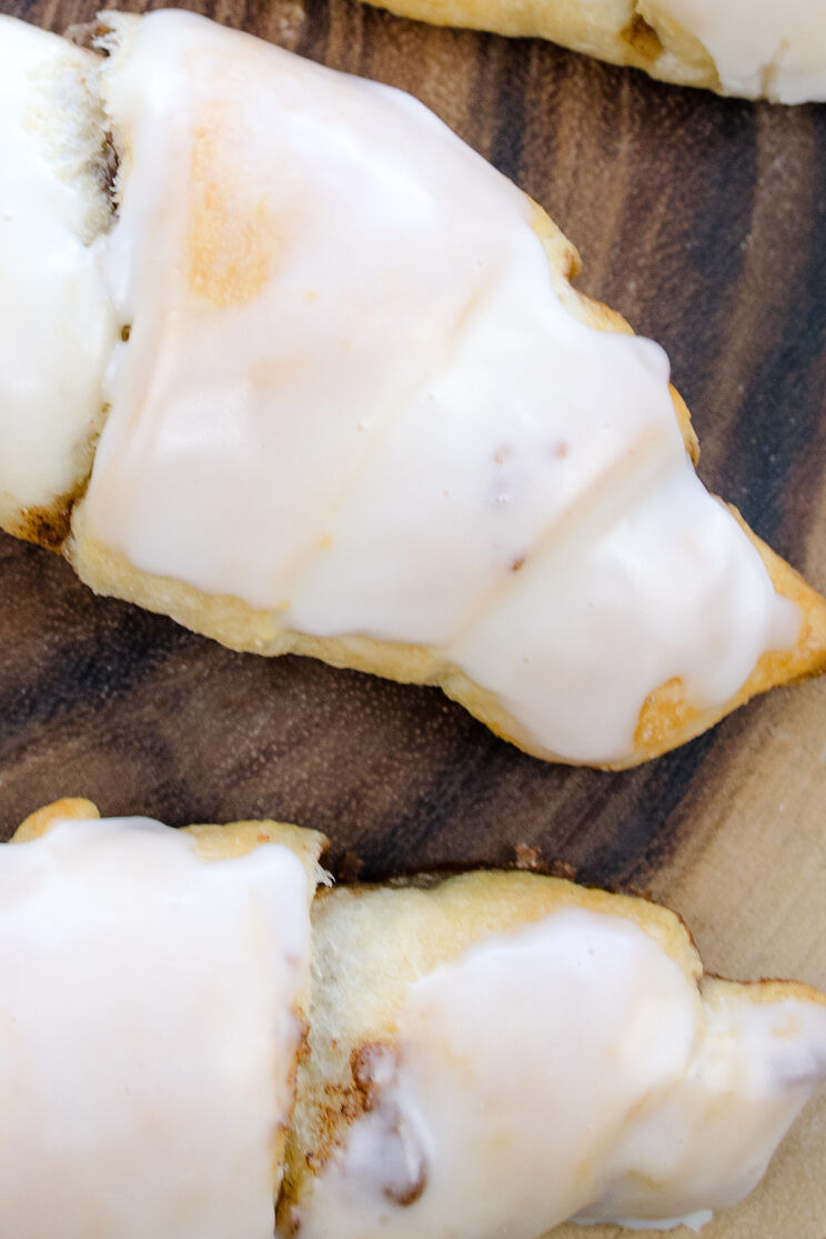 Close overhead view of Cinnamon Crescent Rolls on a wooden surface.