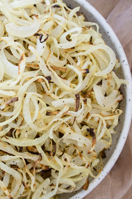 Overhead view of a white plate full of Air Fryer Onions.