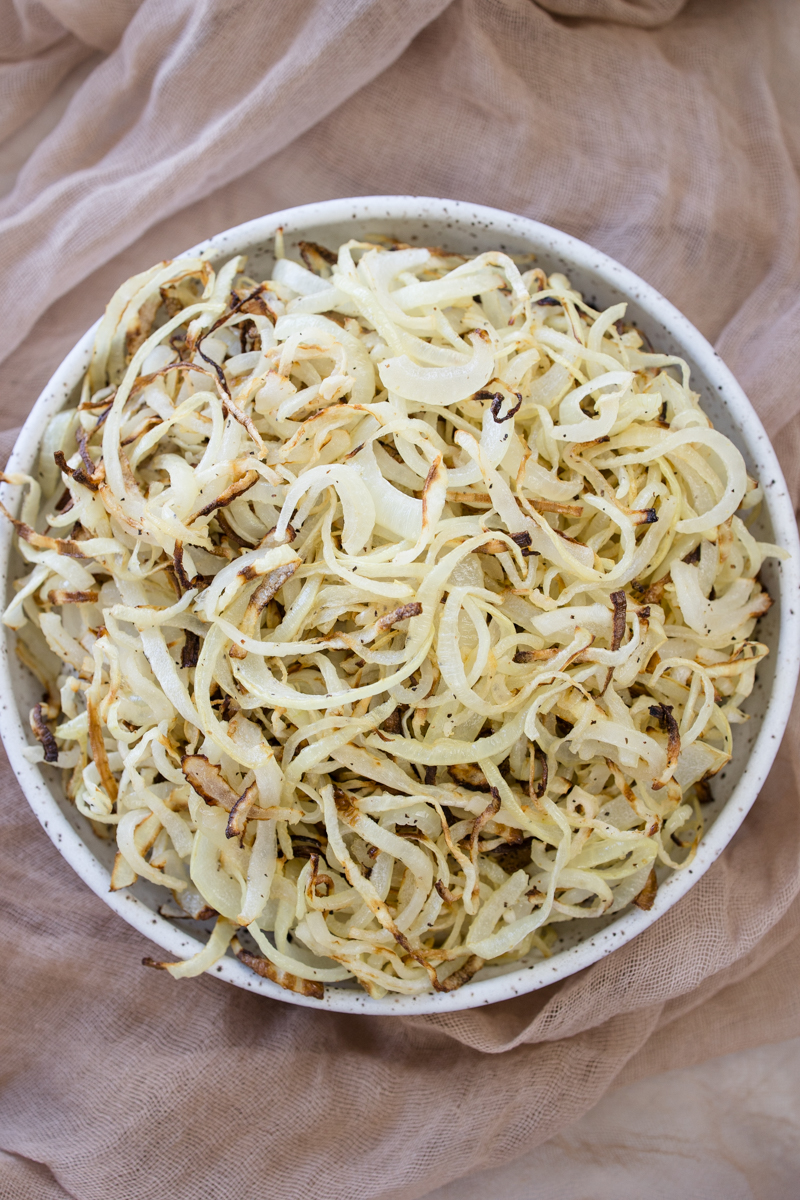 Overhead view of a white plate full of Air Fryer Onions.
