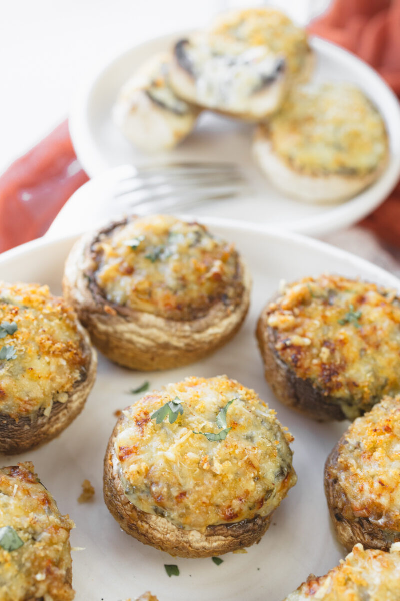 Close up image of Air Fryer Stuffed Mushrooms on a white plate.
