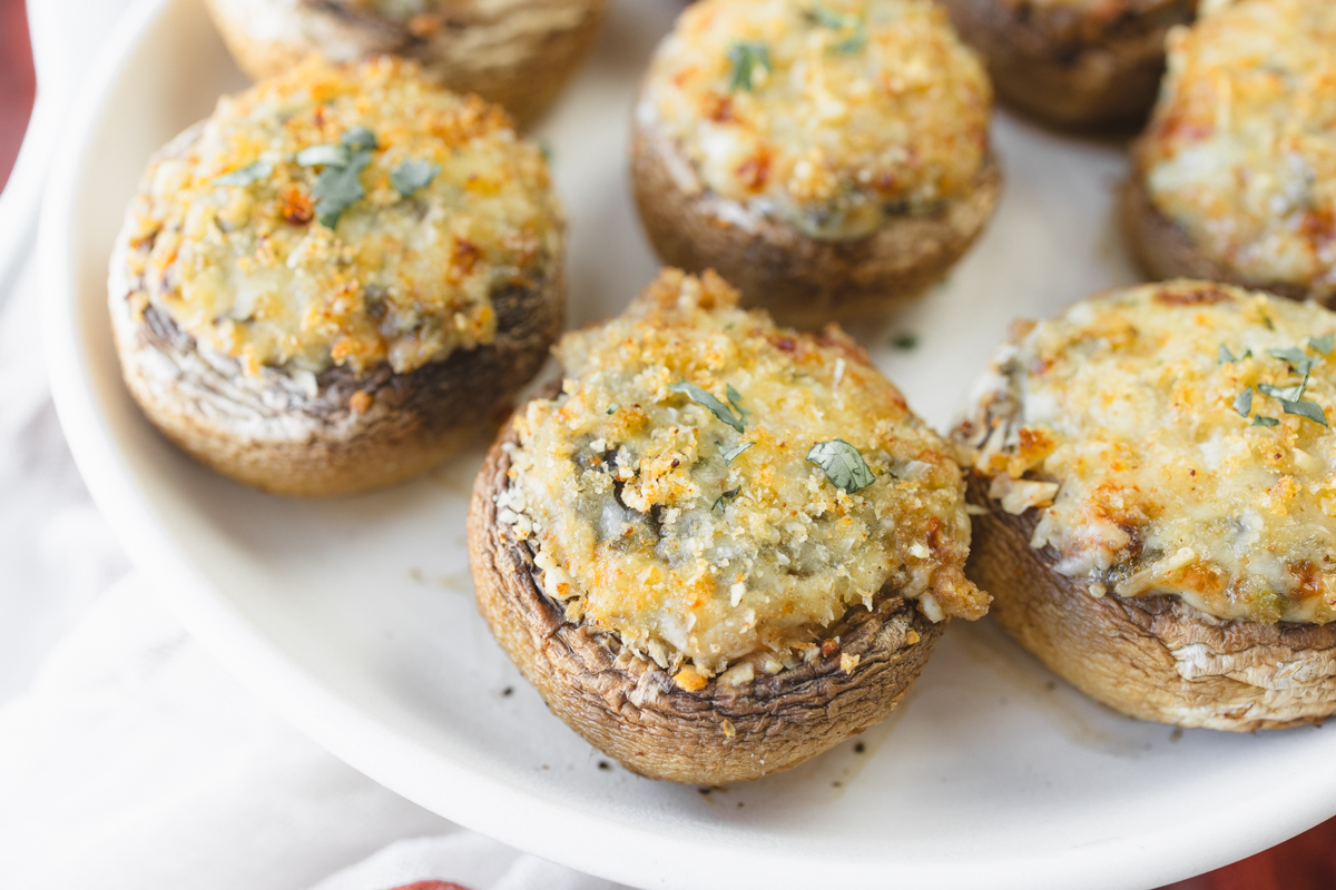 Close up image of Air Fryer Stuffed Mushrooms on a white plate.